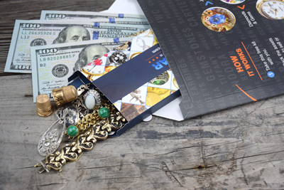 vintage jewelry and bank notes in a redollar selling envelope