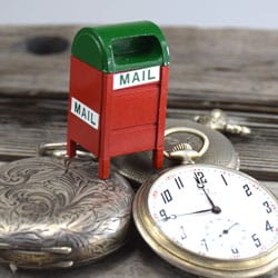 antique pocket watches and Omega pocket watch with mailbox about to ship