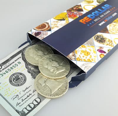 Franklin half dollar coins in shipping box on dollar bill