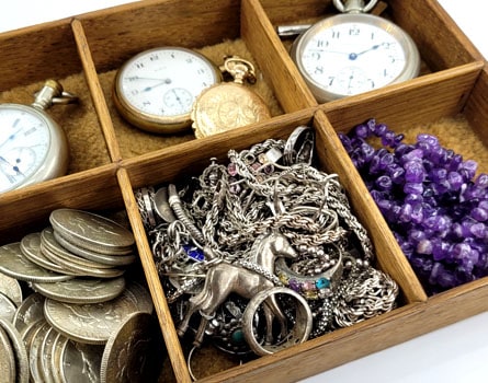Jewelry box with silver jewelry, silver coins, and silver watches