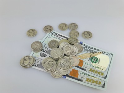 stock image: US silver coins, 100 dollar bills, quarter coins