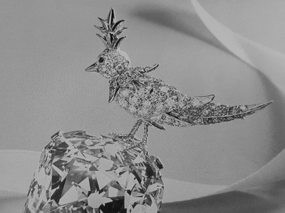 a bird loaded with diamonds is sitting on a Tiffany diamond