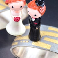 bride and groom on colorful gold wedding rings