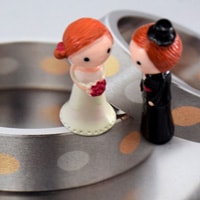 bride and groom on very modern wedding rings