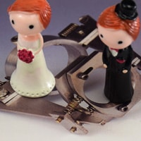bride and groom on spacy steel made wedding rings