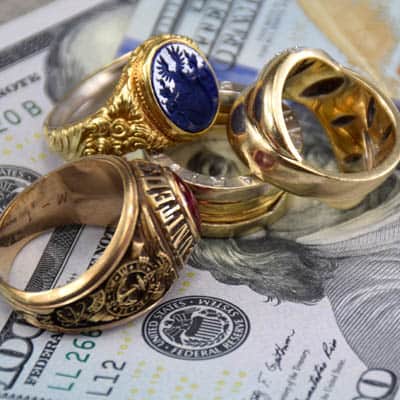 college ring, seal ring, designer ring and diamond ring on 100 us dollar bill