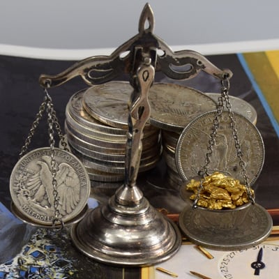 12.52 pennyweight of pure gold on scale compared with US silver coins