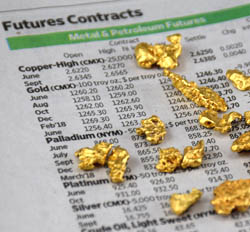 Nuggets on newspaper with current gold price