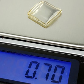 watch crystal weighing on a scale 