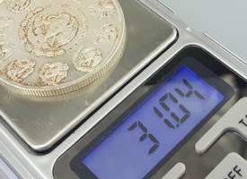 weighing a silver coin with digital scale