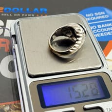 Weighing a 14k white gold ring with scale