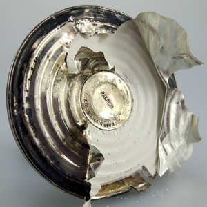 opened bottom of sterling weighted candle holder showing filling materials